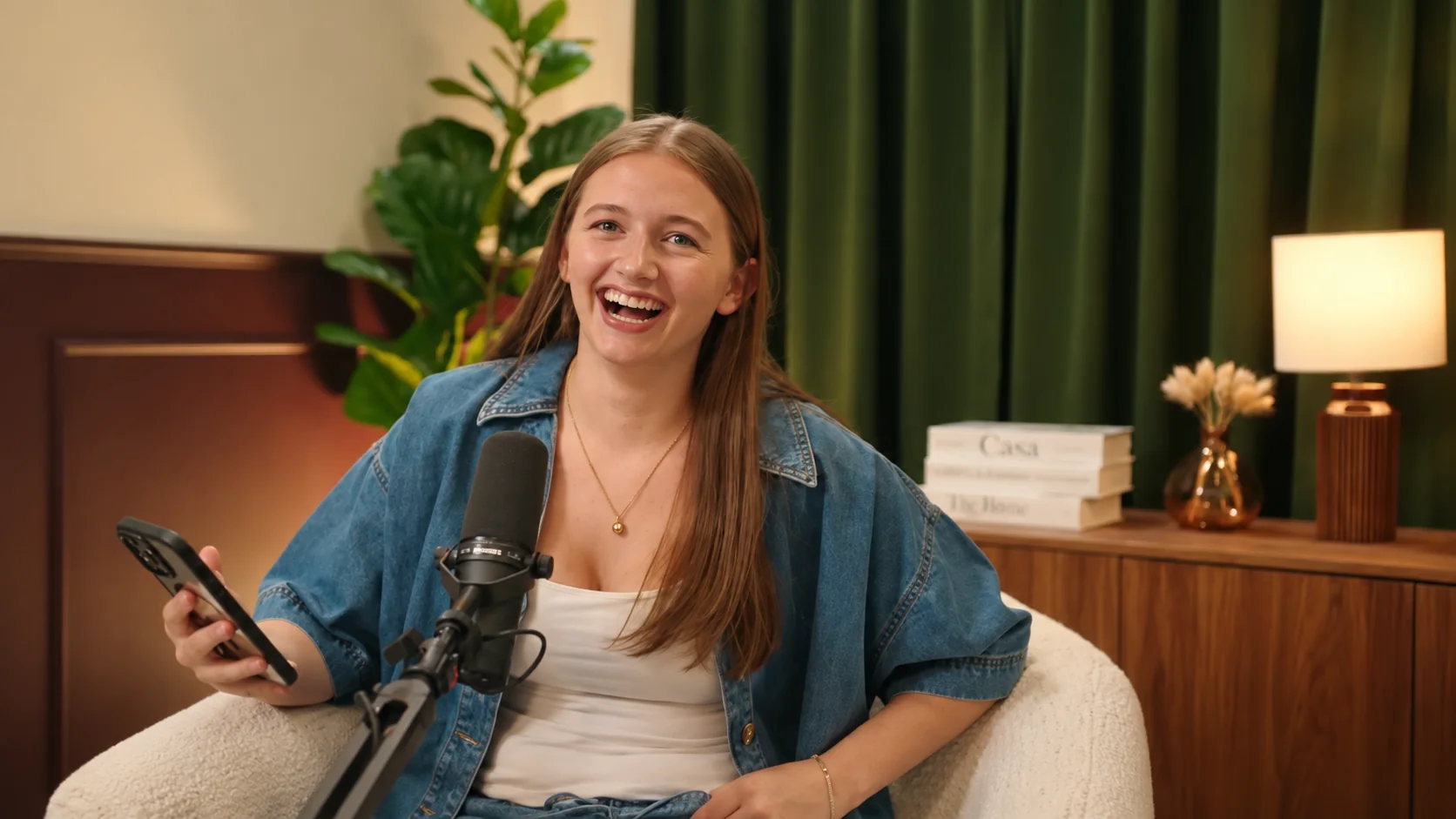 A smiling podcast guest speaking into a microphone in the studio