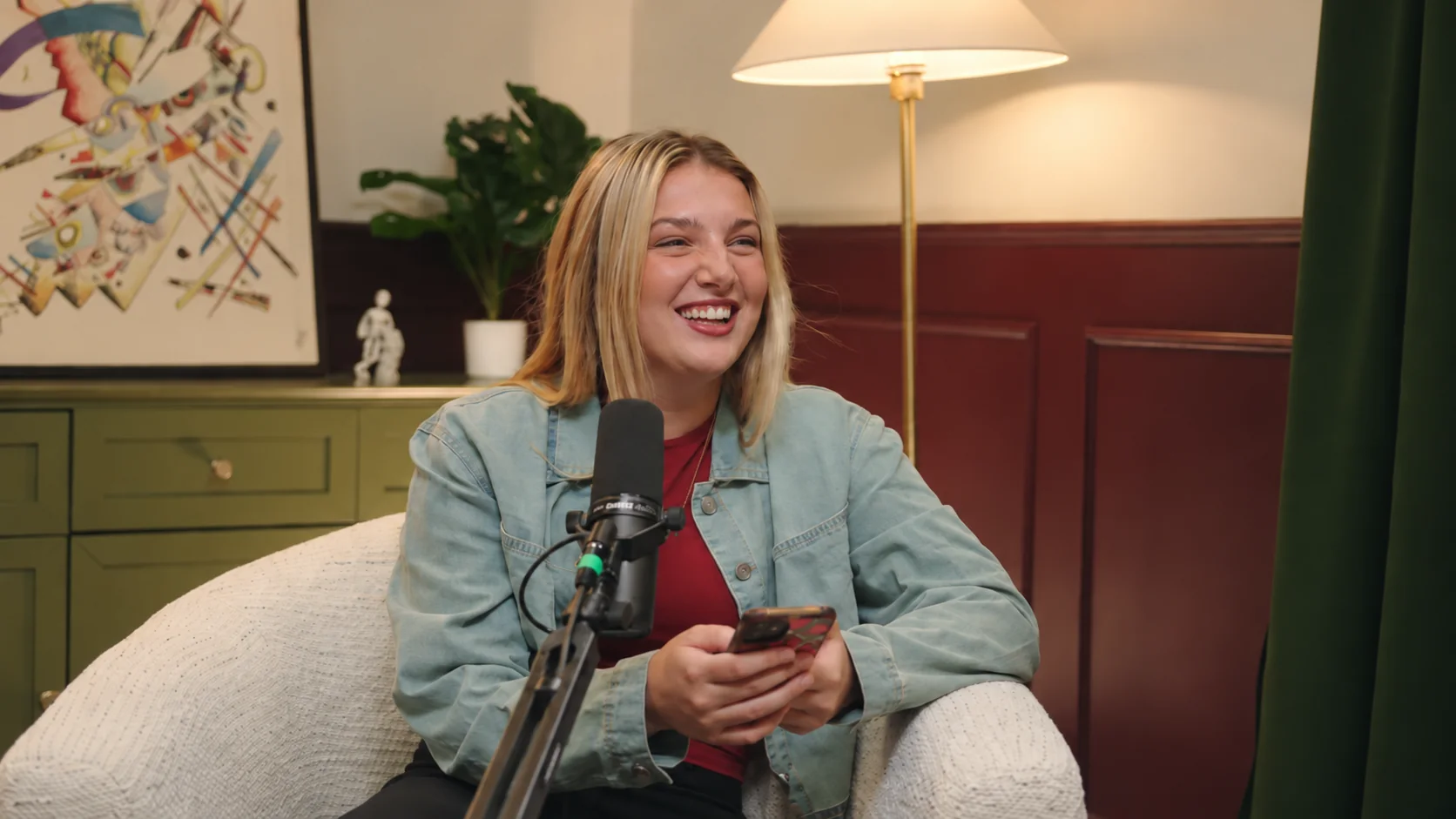 A guest laughing during a podcast recording